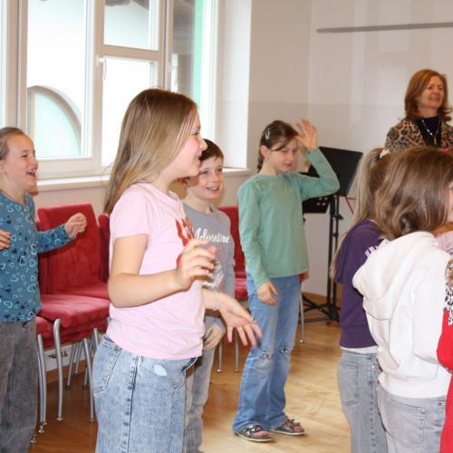 Die Kinder machen Aufwärmübungen fürs Singen.
