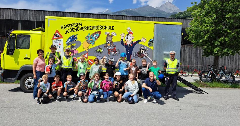 Die Kinder mit dem neu erhaltenen Fahrradführerschein vor dem Verkehrserziehungsbus.