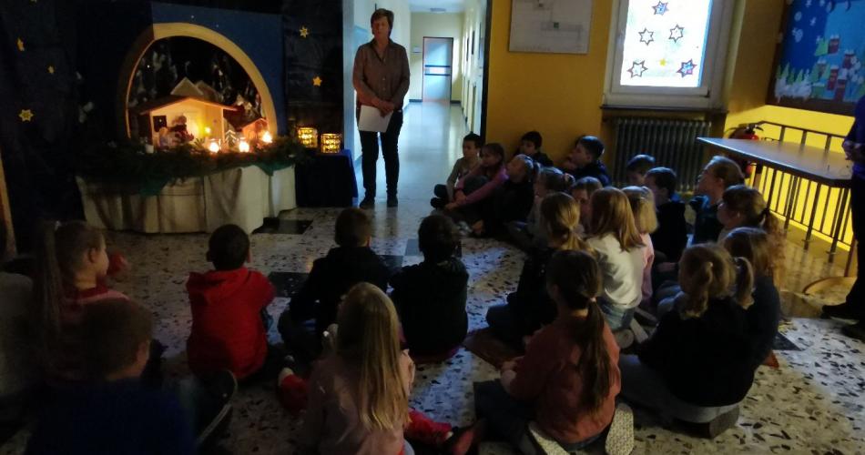 Die Religionslehrerin erzählt in der Adventecke den Kindern Geschichten.